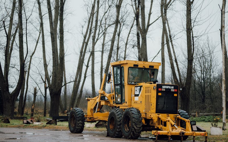 Heavy equipment in forest clearing for lot preparation